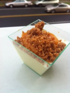 Panna cotta with cloudberry puree and almond crumble.