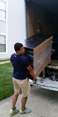 Dependable movers carefully loading a truck.