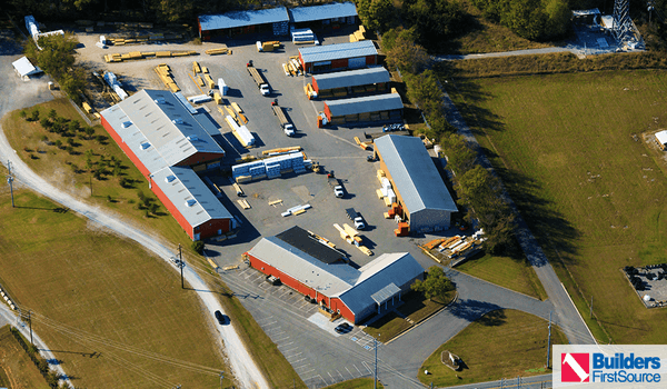 Building materials supplier Builders FirstSource's forklift is moving wood roof trusses.