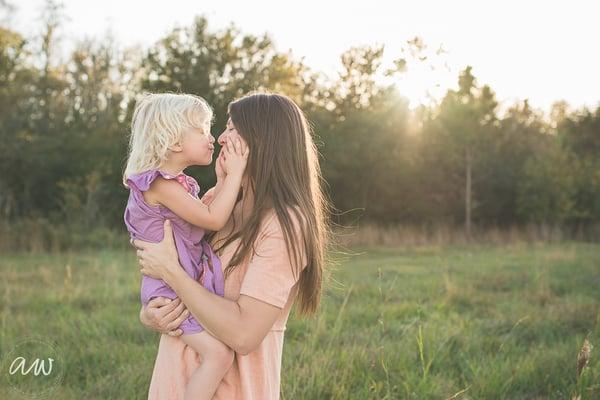 A little girl with her mom in an open field in Wesley Chapel.