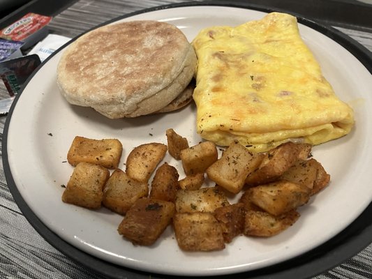 Ham and cheese omelette, home fries and English muffin.