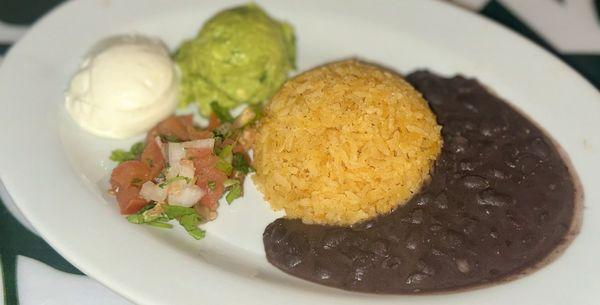 Rice, beans, sour cream, pico de gallo and guacamole which came with fish and fajita entrees.