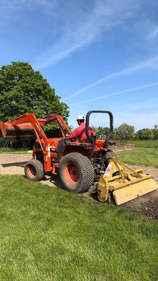 We're using a rototiller to cultivate the area we've recently graded, preparing it for the application of grass seed and a straw blanket