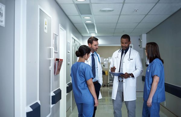 Group of physicians reviewing a chart.