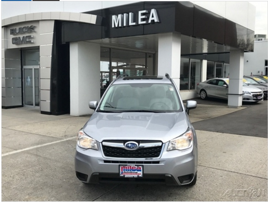 Subaru in front of dealership