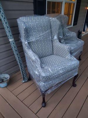 Reupholstered wing chair wrapped in some plastic for delivery Wood also touched up