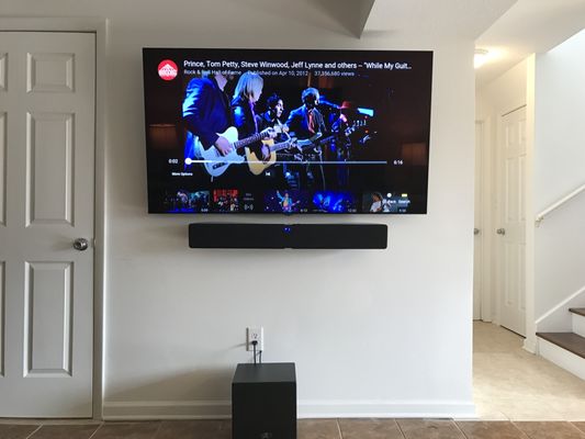 LG OLED, Martin Logan Soundbar and Subwoofer with equipment in the closet.