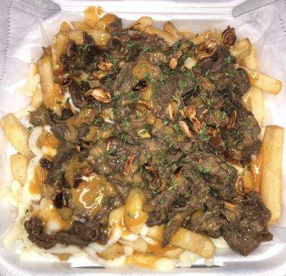 Pandemic Fries - topped with marinated beef, mozzarella cheese, fried onions, parsley flakes, and our signature Bun sauce.