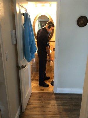 Performing a residential leak detection service.