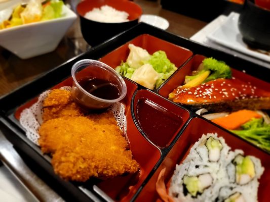 Lunch bento box with pork katsu and teriyaki salmon