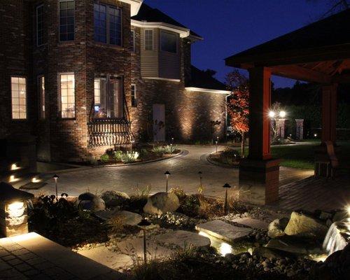 Landscape lighting adds drama to this back patio design!