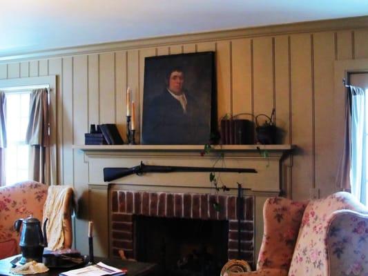 Master bedroom fireplace with late 1700's oil portrait of a gent, leather bound books & mid 1800's muscat