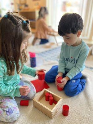 Students working with the red box Montessori materials.