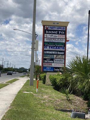 Road signage off Lancaster; business in back.