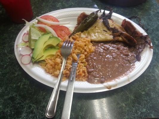 Carne Asada, with rice, beans, salad with avocado, fried green onion, jalapeño and tortilla.