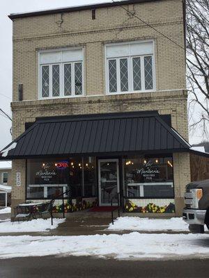 Store front, with plenty of street parking.