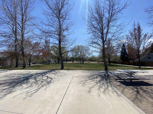 Grassy area with paved walkway around it.