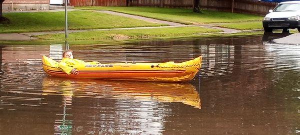 This is my Grandson canoeing   in front of his house in the road.