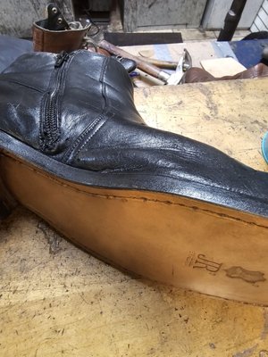 This is the after picture with new sole hand stitched, and new zipper. These boots look like new, yet are over 25 years old.