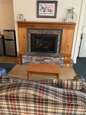 To the right of the fireplace is an outlet and just above that is the carbon monoxide detector