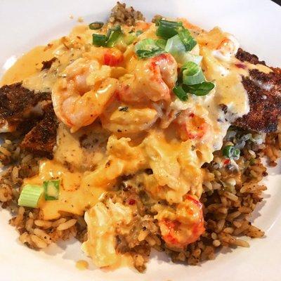 Catfish Charleston - well seasoned catfish, with shrimp, crab, and a crawfish cream sauce, atop dirty rice.