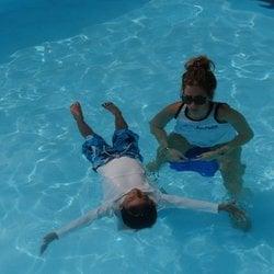 Instructor Alana teaching her student how to float