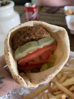 Falafel pita with tomato lettuce and pickle. I asked them to cook the falafel longer than Normal so it's not mushy inside.