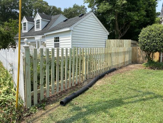 Picket fence, with base height adjusted to match slope of side yard (longer as the fence went downhill towards street).