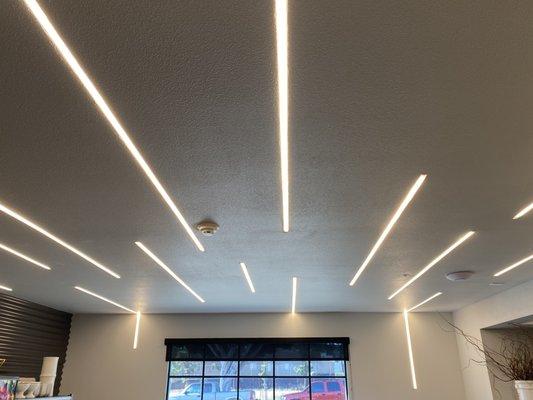 This ceiling and wall installation features recessed LED channels that create both brightness and interest.