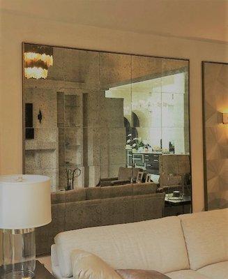 Mirrors can add dimension to your living space. This mirrored tile application also adds a decorative touch to this room.