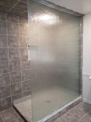 Ceiling to floor glass shower wall