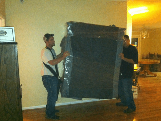 Moving a very heavy piece of furniture with the shoulder dolly. The piece is also padded and shrink wrapped like it should be!