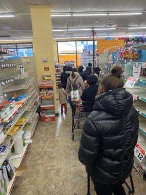 The line. Only one person on the register ringing up while three people are behind the counter talking.