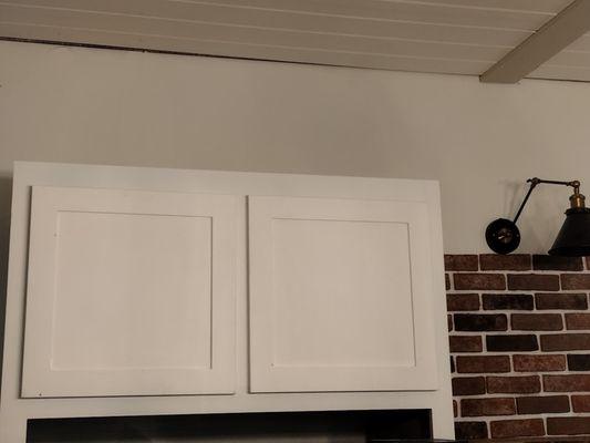 Missing crown molding & there is blue tint in the cabinets.