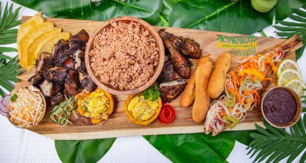 Reggae Platter with Jerk Chicken, Jerk Pork, Escovitch Fish, Rice and Peas, Festival and fry breadfruit