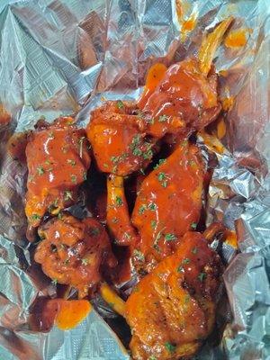 Buffalo wings in homemade buffalo sauce.