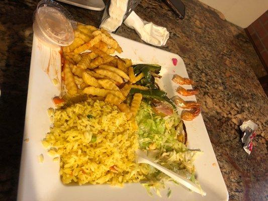 Burnt rice, 4 shrimp and salad. It's not supposed to have the fries , I added those, they charging me extra for that.