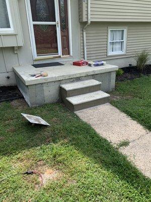 Front steps stuccoed, you can see the steel mesh behind