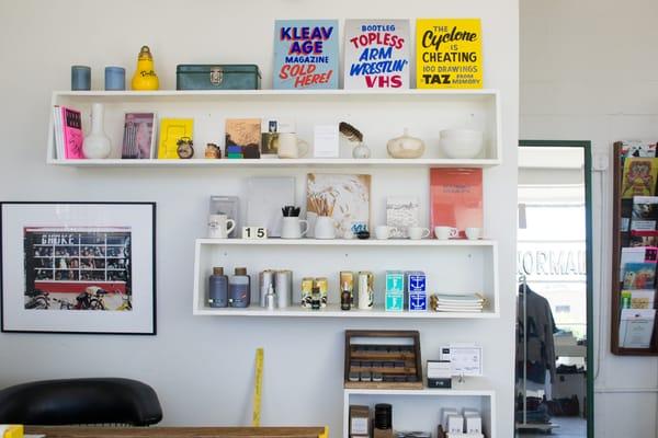 Our wall of curiosities, Juniper Ridge grooming supplies along with Kleavage entertainment products.