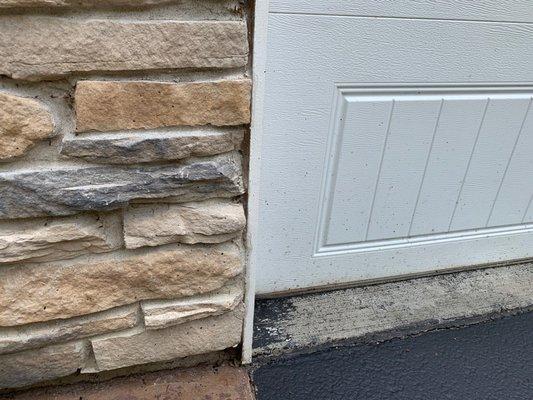 Tar speckles all over white garage door.