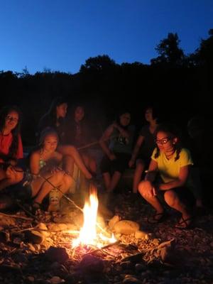 Enjoying a camp fire at camp along the river