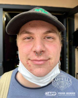 Fresh septum piercing with a 12g, 1/2" circular barbell. Pierced and photographed by Cat!