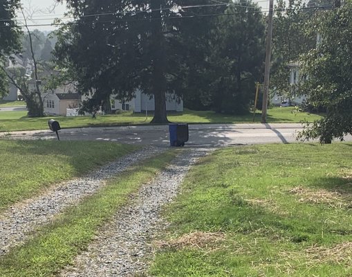 Trash can in middle of driveway.