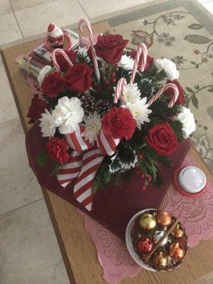 Candy cane arrangement with red roses and white carnations.