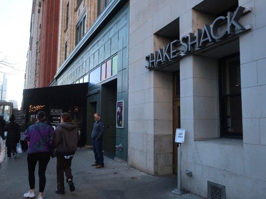 Signage right next to the entrance of the historic Chicago Athletic Association Hotel.