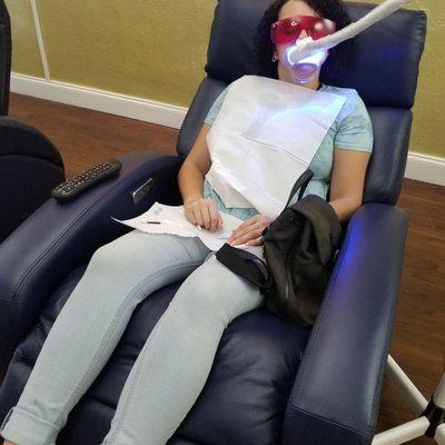 Client enjoying teeth whitening experience.