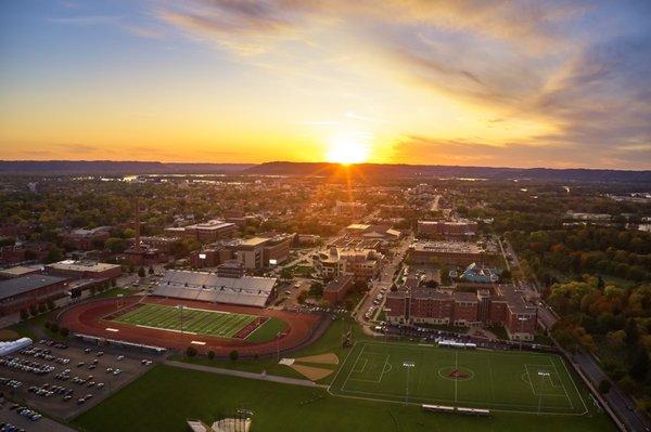 A sunset view of the UW-La Crosse campus with Veterans Memorial Field Sports Complex in the foreground.