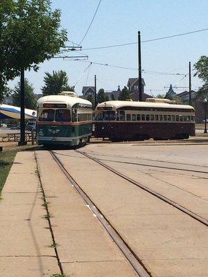 Two Kenosha Electric Railway streetcars pull into the station yard at 724 54th Street. A radio station broadcasts information at 1610 AM.