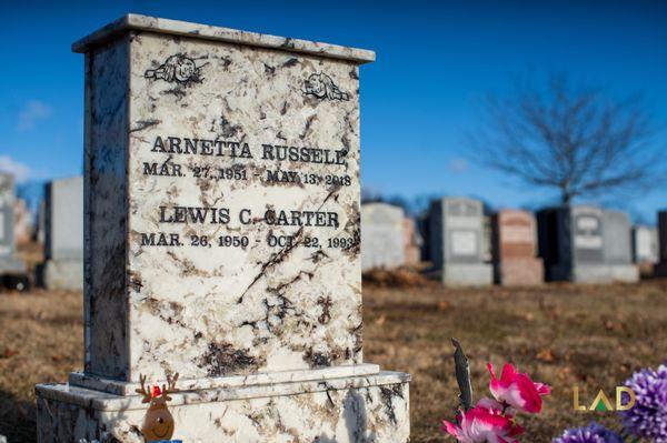 Marble headstone, with etched doves on the top corners.