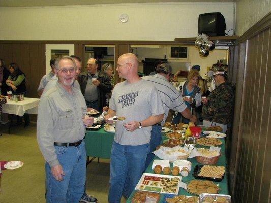 Dennis and Joe enjoy a Christmas party cookie, or two, or three.